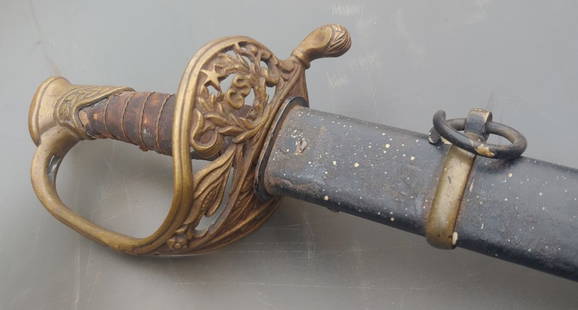 Confederate staff officers sword w/ Rebel Snake Hanger Clip: Very nice Richmond, Virginia Boyle and Gamble staff sword with star and CS in the guard in original brass mounted steel scabbard which was produced in Richmond or Kenansville NC. Still attached to the