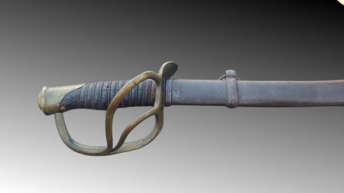 1862 Providence Tool Company Cavalry Saber: Early war and one of the scarcer contracts. Christopher Roby 1862 and so marked and inspected. Complete with scabbard. 100% original and complete. VG condition. Some wear and age on the leather grip. 