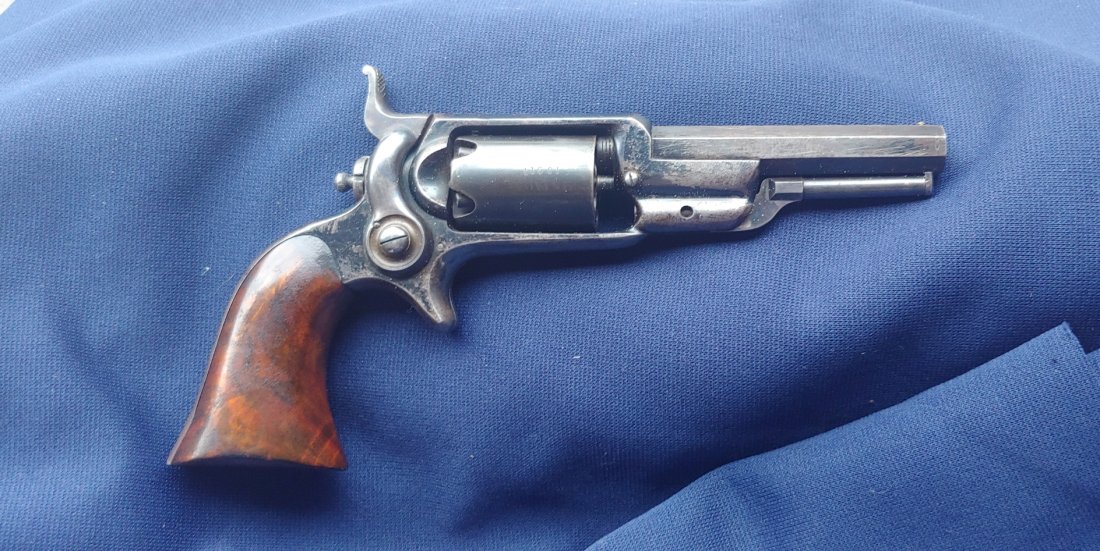 High Finish 1855 Colt Root Revolver: Fine condition Root. 60% lustrous factory blue on the left side of the barrel and frame. 20% blue on right side of barrel. 60% blur on right frame. Traces of color case hardening on the hammer and ram