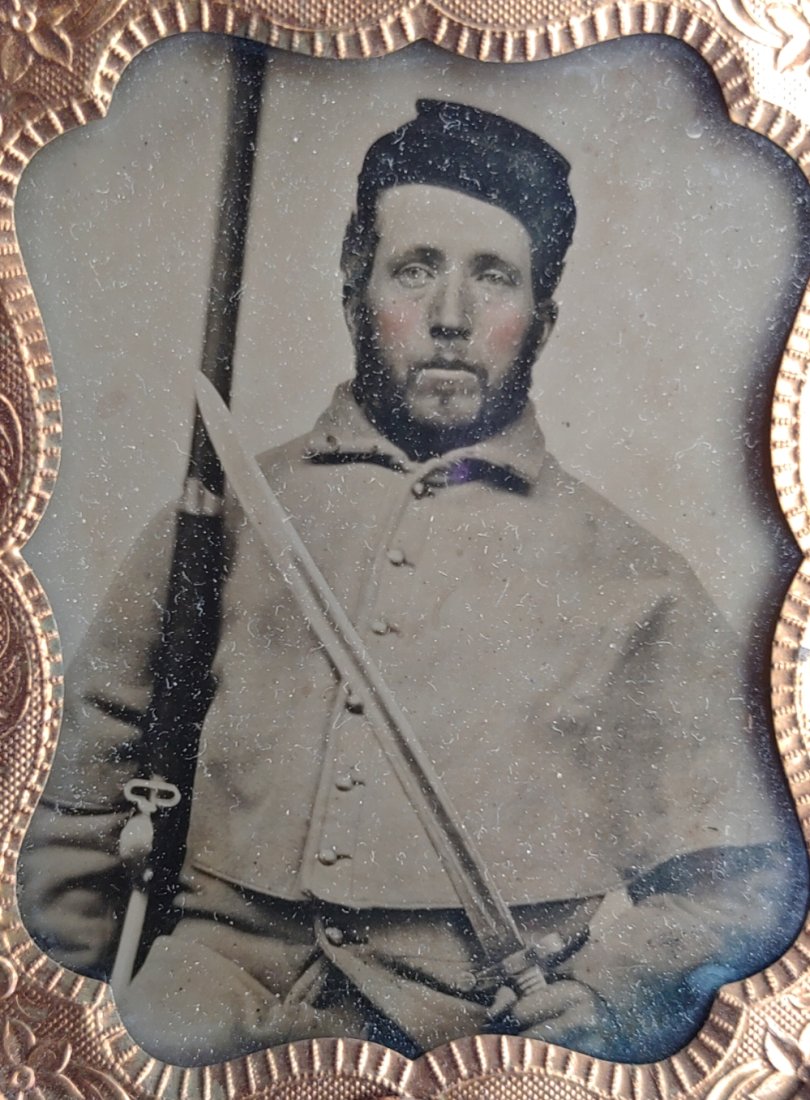 9th plate Tintype Soldier w Mississippi Rifle & Saber Bayonet: Fine clear ninth plate tintype showing Yankee in winter greatcoat displaying is brass handled saber bayonet, and m1841 Mississippi rifle. Really sharp. Add $25.00 for materials, packing, and shipping.