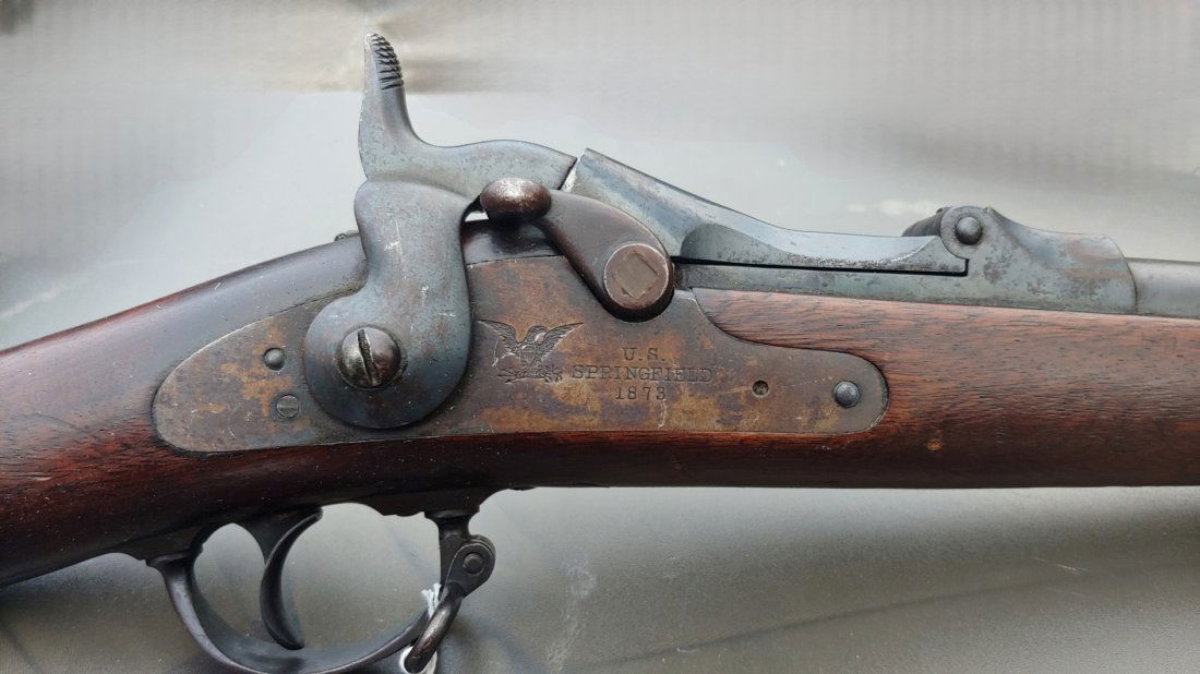 True 1873 Trapdoor Springfield Rifle made in 1874: Earliest production 1873 Springfield 45/70 Trapdoor rifle. Lock is dated 1873. Serial number is 32,339, 1874, the first full year of production. Cartouche is early form ESA in an oval. The breech bloc