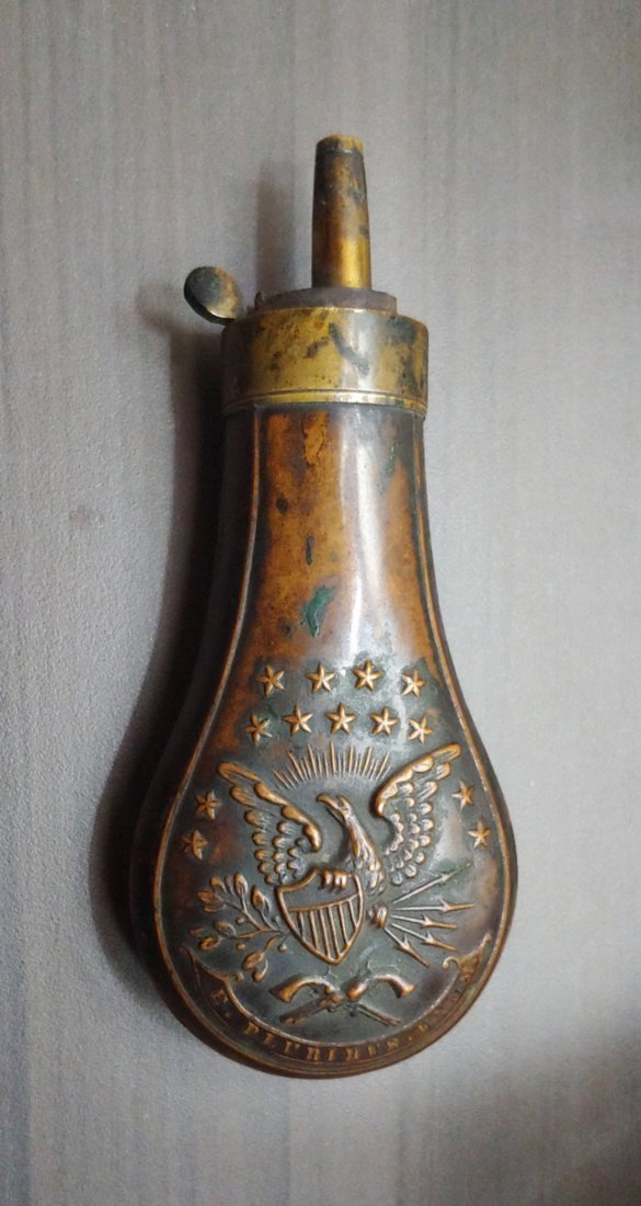 Powder flask for pocket Colt: A very handsome original powder flask for the 1849 Colt Pocket revolver. Super color. Great eagle die strike. The only defect is the broken spring which I will leave for you to replace. Measures 4 and