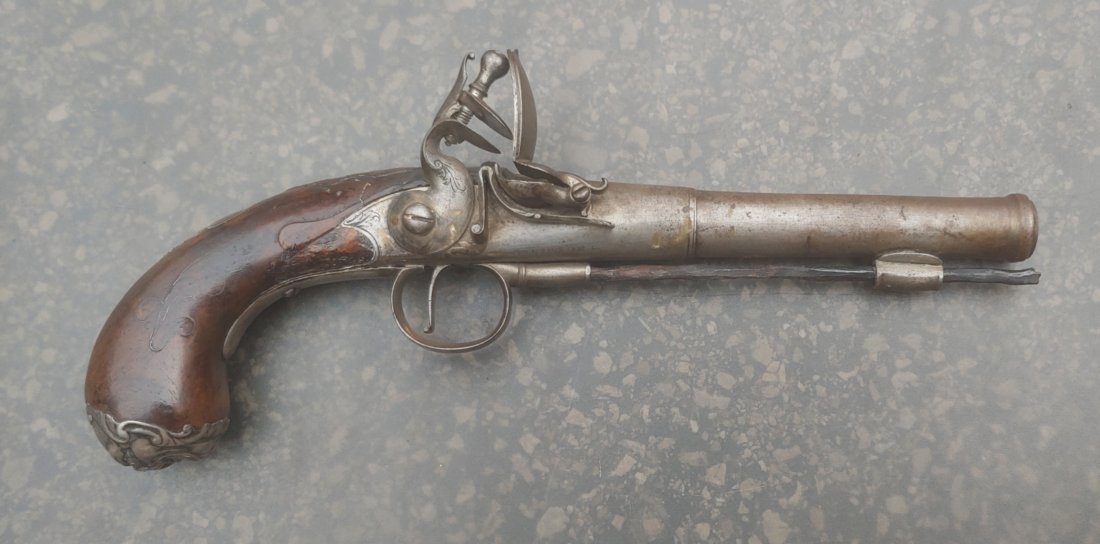 Really great 18th century flintlock pistol by E Newton Grantham: Circa 1750 Large Queen Anne style silver inlaid Cannon Barrel flintlock pistol marked E. Newton at the breech and Grantham (town in Lincolnshire) on top of the barrel. About 52 caliber. Original Flint