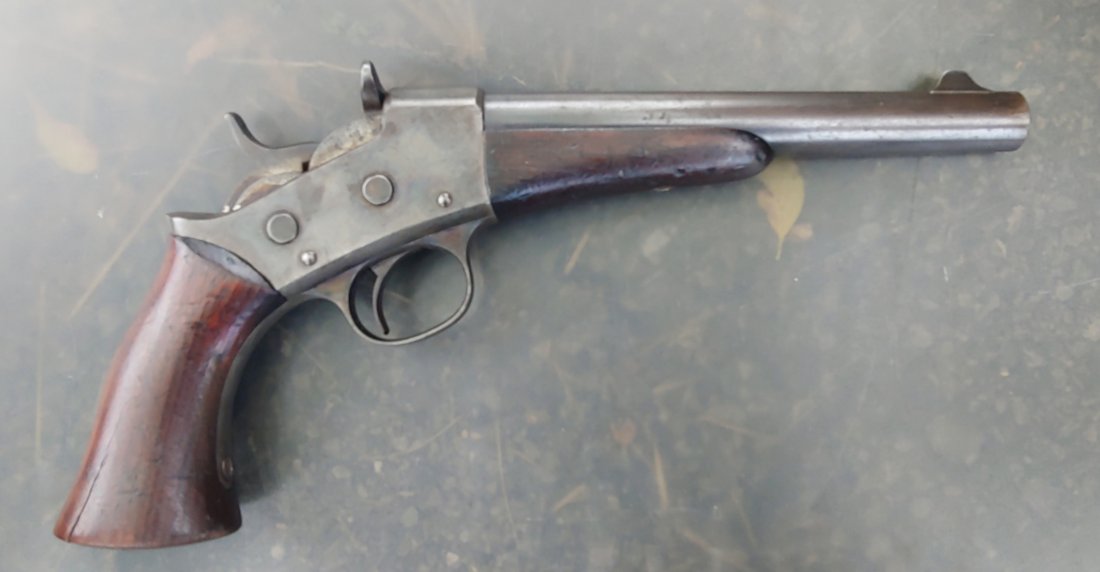US Martial 1871 Remington Rolling Block pistol: Very good to fine condition with excellent walnut grip and forend, smooth plum barrel with thinning blue finish, and hints of case color on the frame. Markings include REMINGTON-S ILION, N.Y. U.S.A --