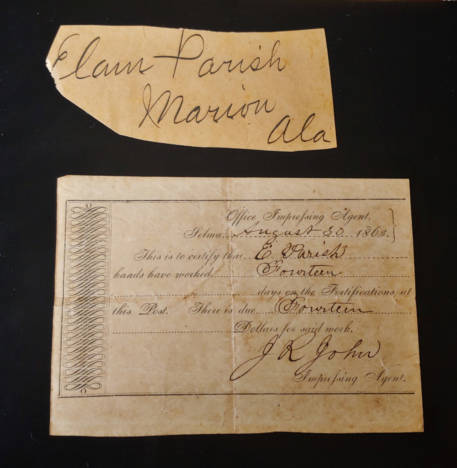 Confederate States document Selma Alabama Arsenal slaves working on fortifications: 4x6-inch pre-printed document dated August 30th 1863 allowing slave owner Elam Parish payment for 14 days work by one of his slaves. The slave having helped in the earthworks construction at The Selma