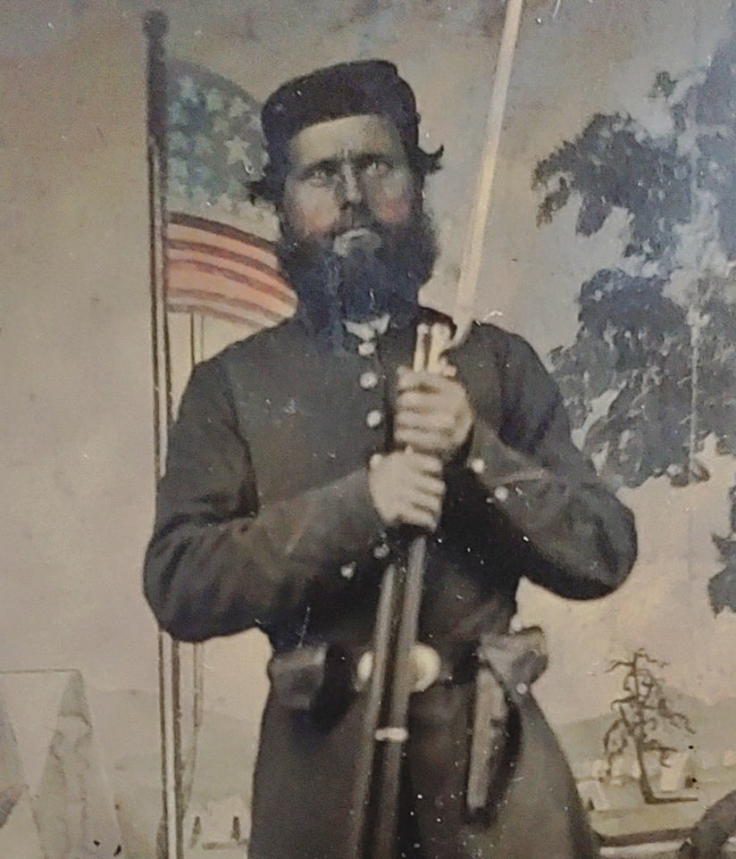 Quarter plate tintype armed civil war soldier patriotic backdrop: Very very appealing Civil War tintype of a tall and tough Yankee ground pounder standing before a hand tinted patriotic photographer's back drop. He is resting on his bayonetted Enfield rifle musket a