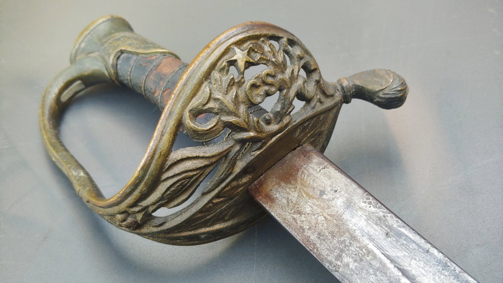 Confederate staff officers sword with an etched blade.: This is the iconic Confederate staff officer's sword with the letters CS and a five pointed star cast as part of the Guard . Made by Boyle and Gamble in Richmond Virginia. These are usually found with
