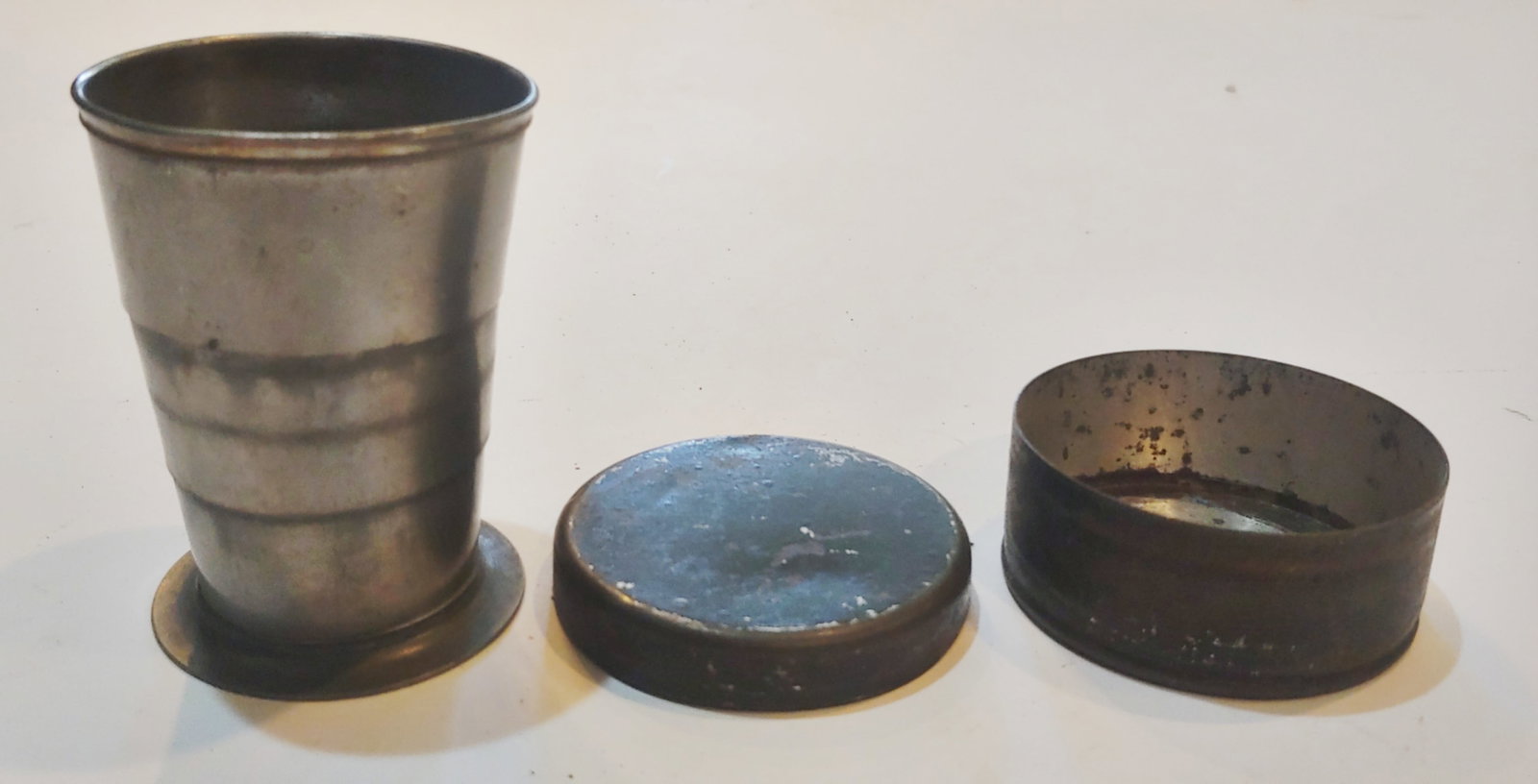 Civil War collapsible drinking cup: Excellent condition , 1860s collapsible pewter traveling drinking cup in the original tin carrying case . $20 for packing UPS shipping, and Signature Required service. UPS charges $6 to obtain a signa