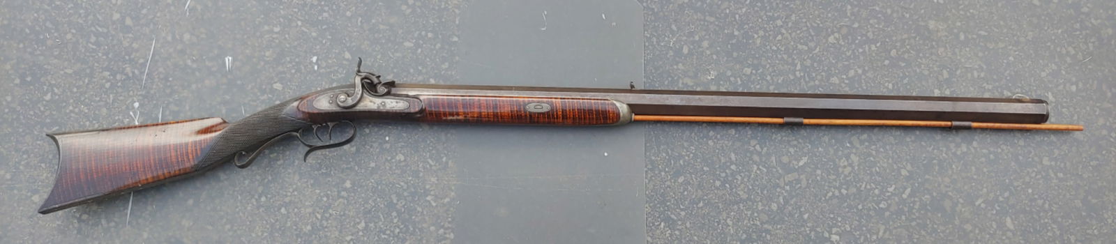Extra high quality heavy barrel half stock percussion target rifle: Extra fine quality and workmanship are the earmarks of this rifle. From the stripe in the wood, to the checkering at the wrist, to the fit and form of the lock this gun is top drawer all the way. 100%