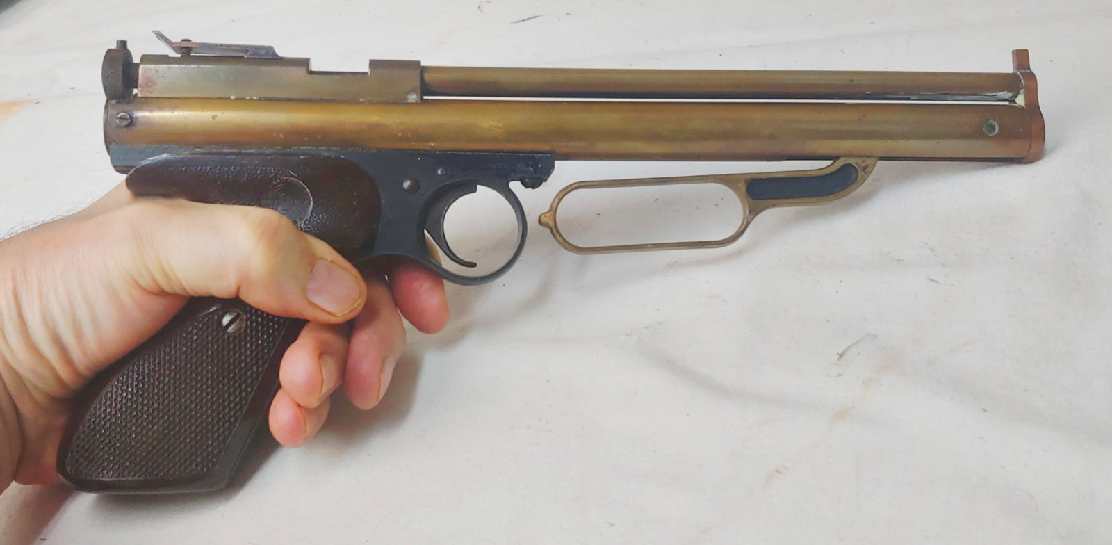 Crossman Arms Company high quality Precision pellet pistol: A very high quality 177 caliber single shot pellet pistol . It cocks by means of a Winchester style lever underneath the barrel . Precision machined in brass . Rifled barrel. It needs a new pad on the