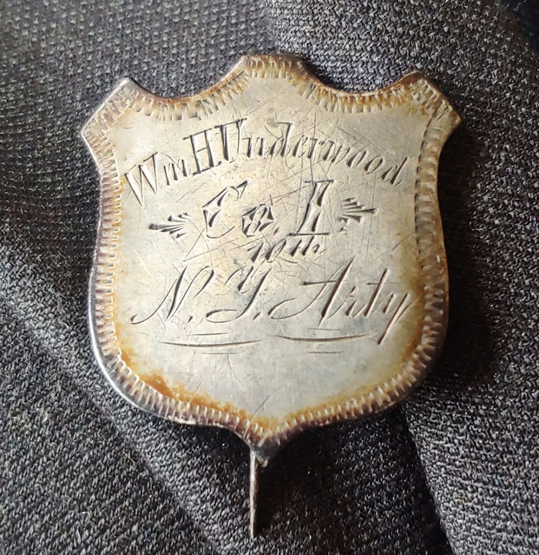 Civil War 10th New York Artillery Silver Shield ID badge: The standard solid silver Civil War pin back identification shield . This one is beautifully engraved Wm. H Underwood Co. I 10th N. Y. Art'y Excellent condition . The t-bar pin is intact the loop catc