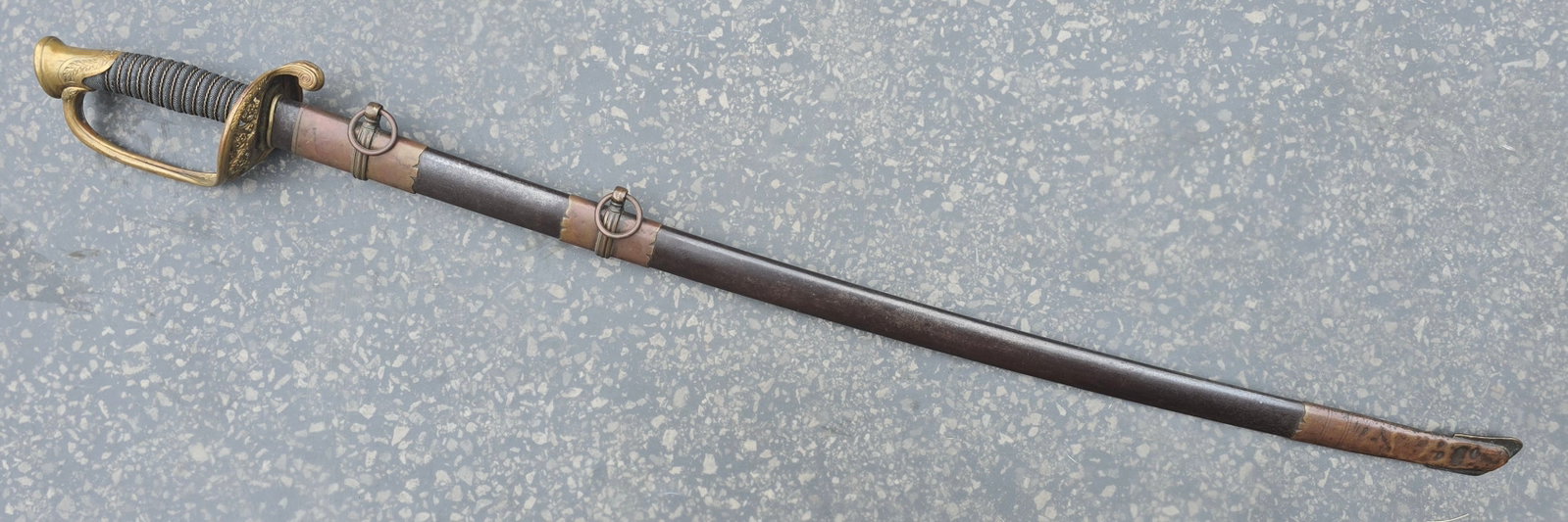 Civil War Foot Officer's Sword in Brass Mounted Steel Scabbard: A solid and handsome model 1850 Union Army Foot Officer's sword in a highly desirable brass mounted steel scabbard. Overall VG condition. Etched blade shows wear. 100% original and complete. This one 