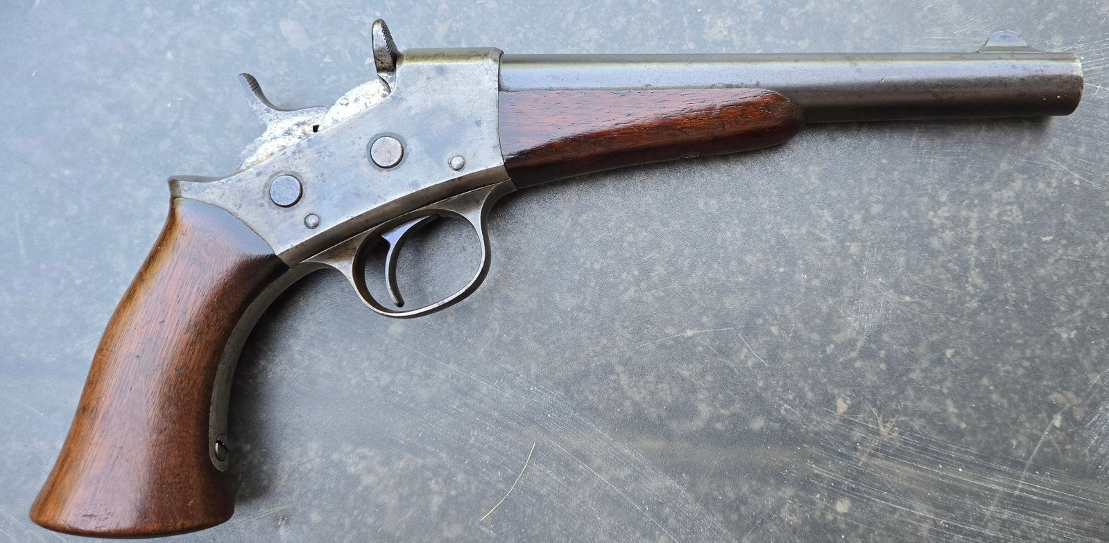 Martial Remington Model 1871 Rolling Block Army Pistol: A truly fine example of the scarce and desirable 50 caliber US Pistol. 8" barrel retains most of the factory blue finish... some thinning. The frame retains 40% to 50% factory case colors. This is one