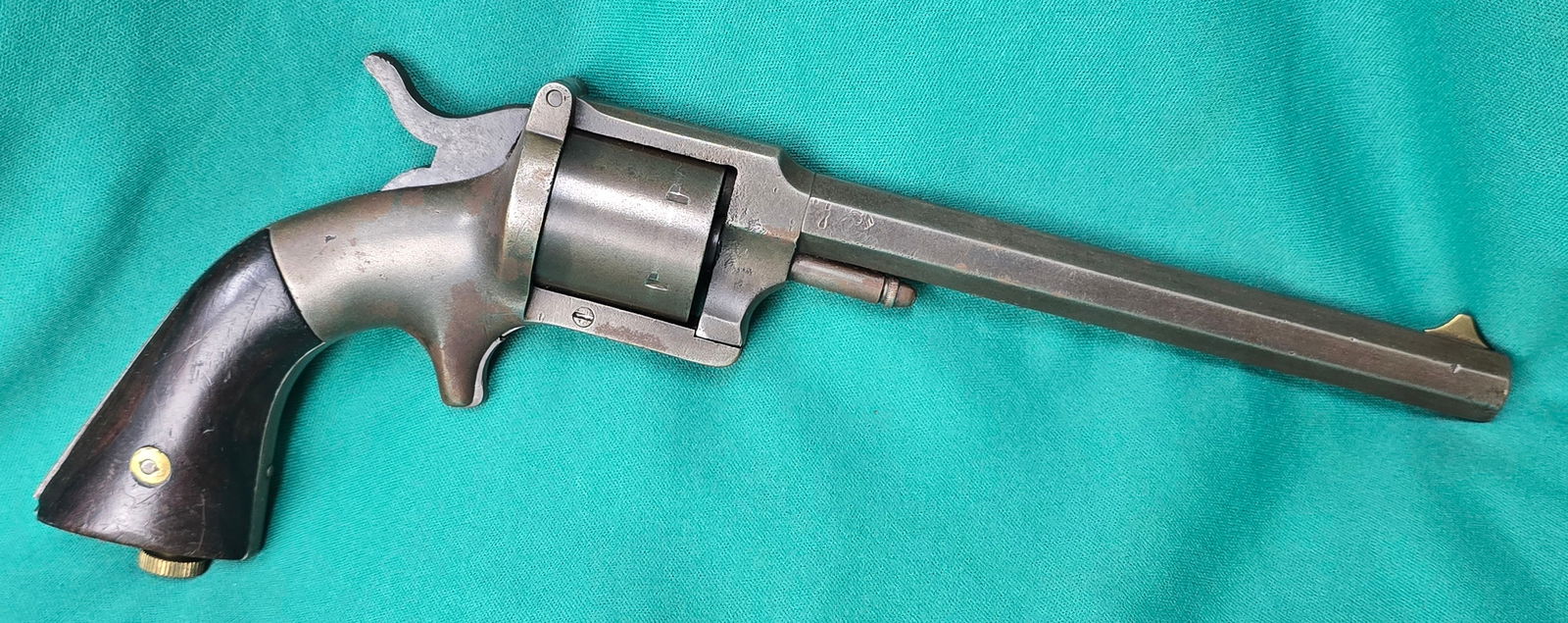 Civil War Pond Revolver: Serial #778, 32 RF, 6'' octagon barrel with dark but good bore showing clear rifling. The metal surfaces of this revolver have mostly toned to a pleasant gun metal gray patina. All of the markings are