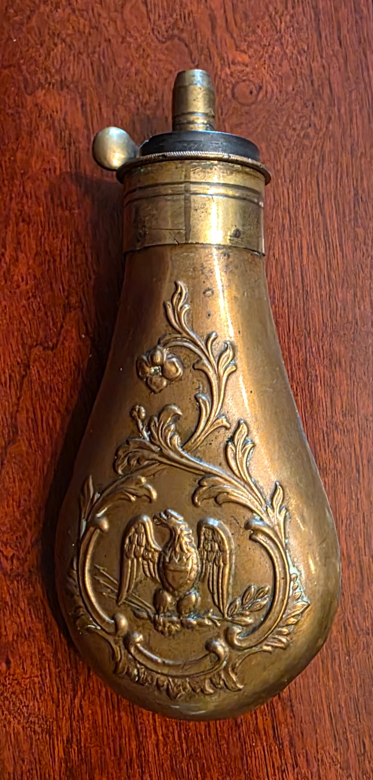 Top quality Eagle motif copper powder flask for a pistol: slightly larger than the Colt pocket flasks we see so frequently . Excellent condition. Beautifully embossed with with an American Eagle holding arrows and Olive branches and Floral motifs. Dates Circ