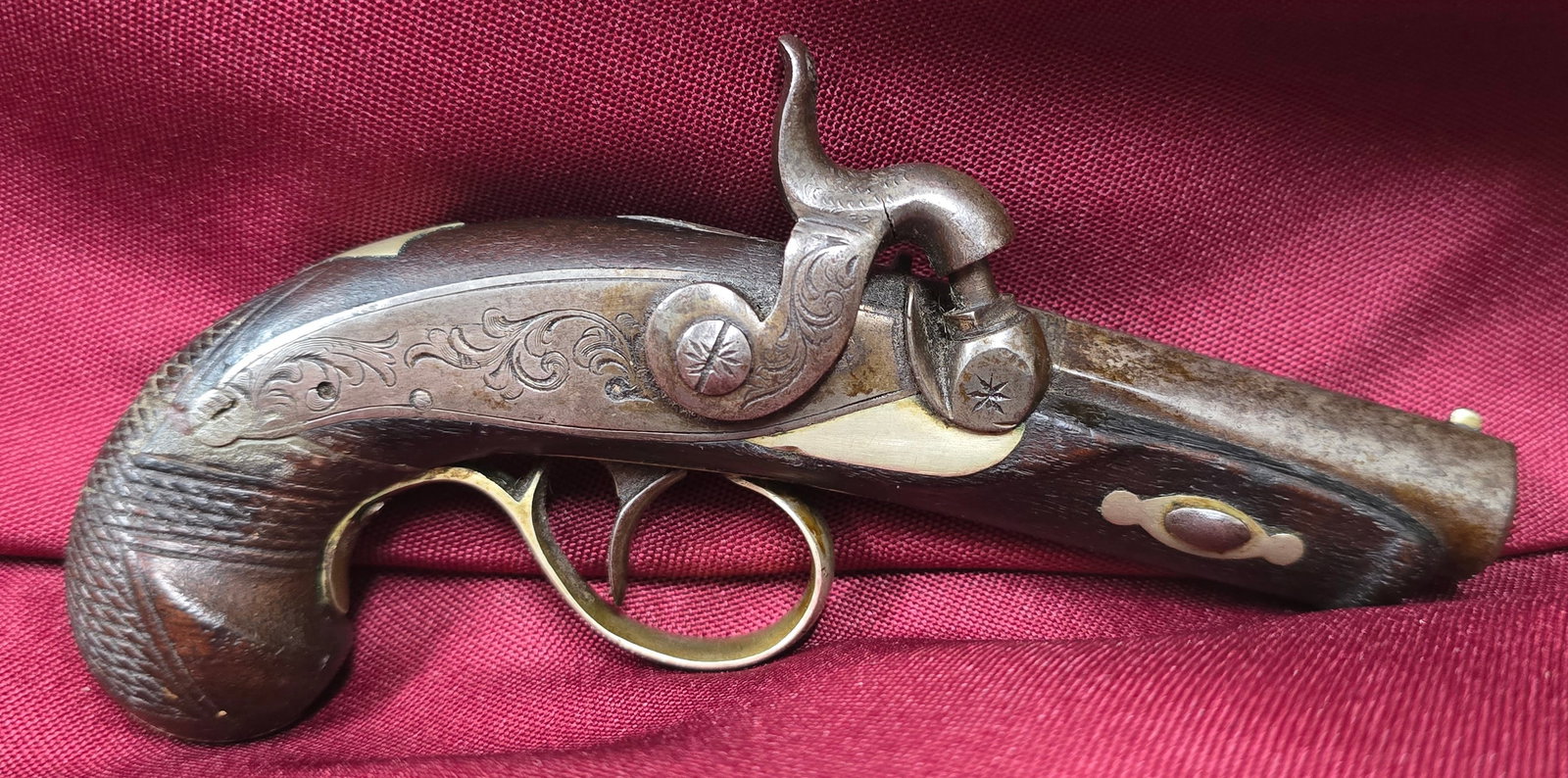 Pair of 19th C. Derringer Percussion Pistols: Popularly known as "vest pocket" pistols. These are original period pieces showing a natural aged patina on the metal components and well-preserved wood grain on the grips. The derringer became an ico
