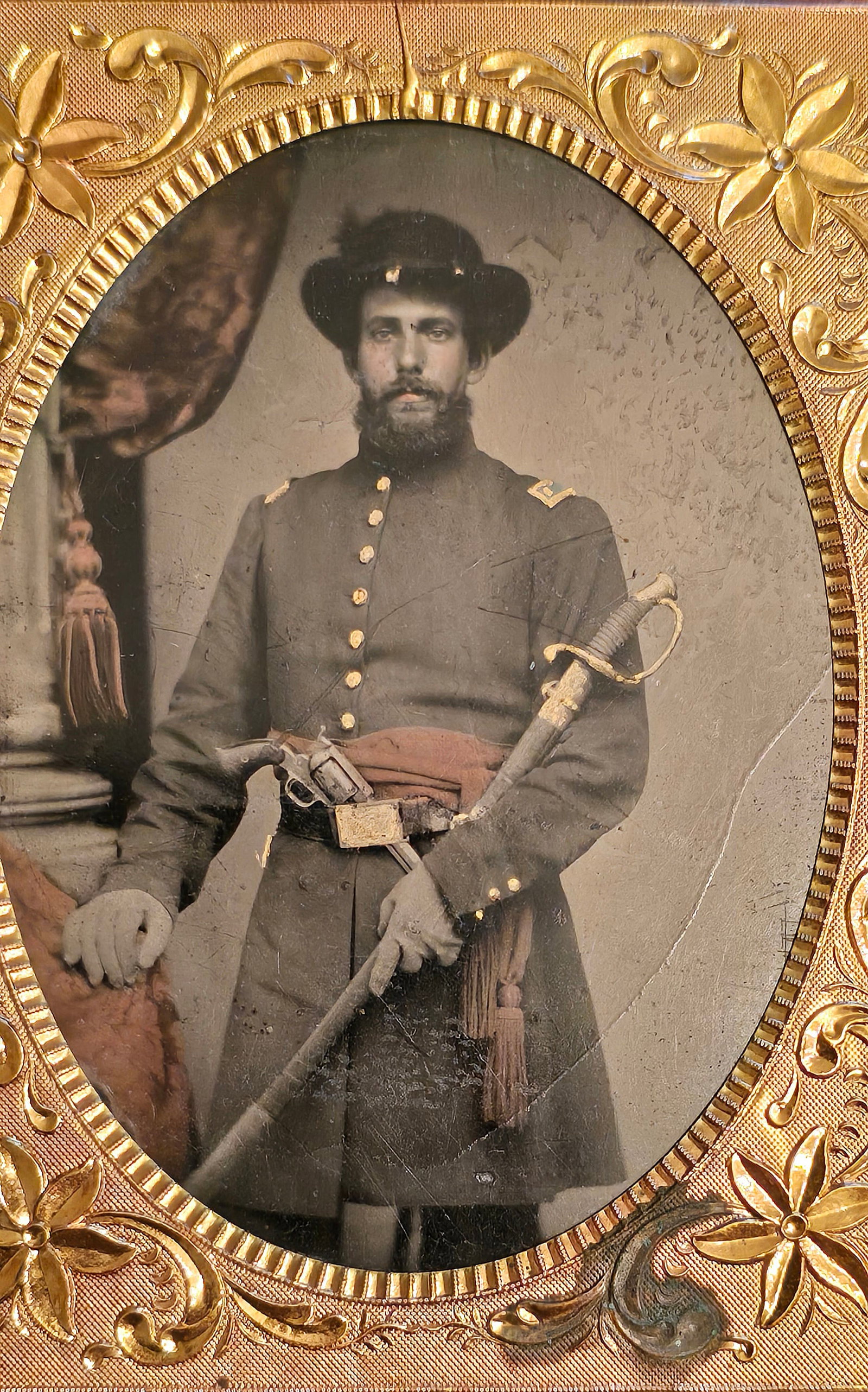 Ohio officer who captured Confederate Sword Quarter Plate Tintype: NEEDS MORE INFO Striking an imposing, battle-ready pose against a classical studio backdrop, a Civil War Union officer gazes directly out from this spectacular hand-tinted tintype, practically