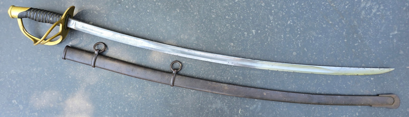 U.S. Model 1860 Light Cavalry Saber: Civil War U.S. Model 1860 Light Cavalry Saber by Ames Mfg. Co. (Dated 1864)An authentic American Civil War U.S. Model 1860 Light Cavalry Saber with its original steel scabbard. The 35-inch curved sing