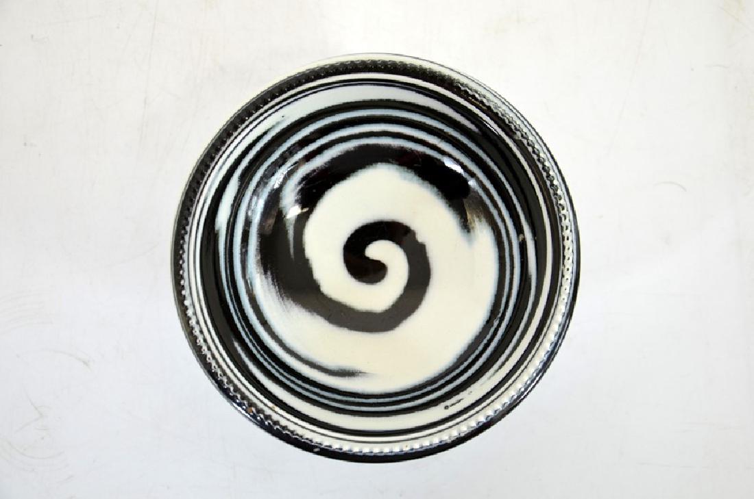 Norman Wilson for Wedgwood, an agate glazed bowl, black: Norman Wilson for Wedgwood, an agate glazed bowl, black and white spiral design, pedestal cup form with beaded foot and rim, printed and impressed marks and NW, 11.5cm diameter