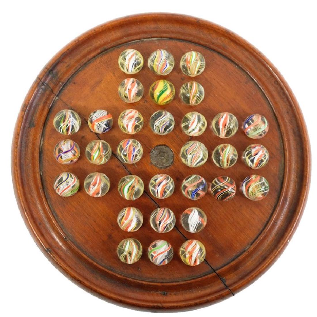 A mahogany solitaire board and 32 brightly coloured (1 of 1)