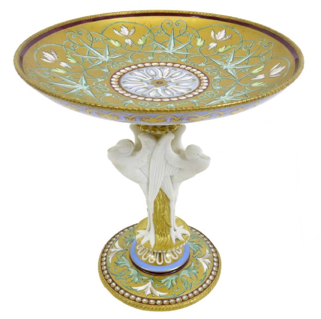 Leon Arnoux (attributed) for Minton, an Aesthetic: Leon Arnoux (attributed) for Minton, an Aesthetic Movement tazza, circa 1862, the stem modelled as three storks supporting a beaded knop and shallow dish, gilt decorated with stylised leaf and vine de