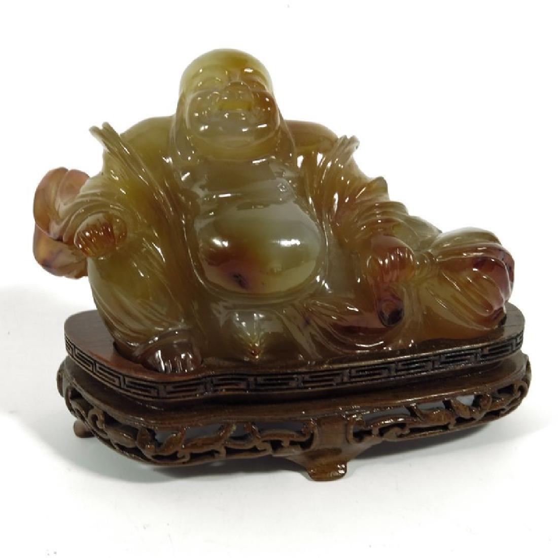 A Chinese carved stone Buddha, agate, modelled (1 of 4)