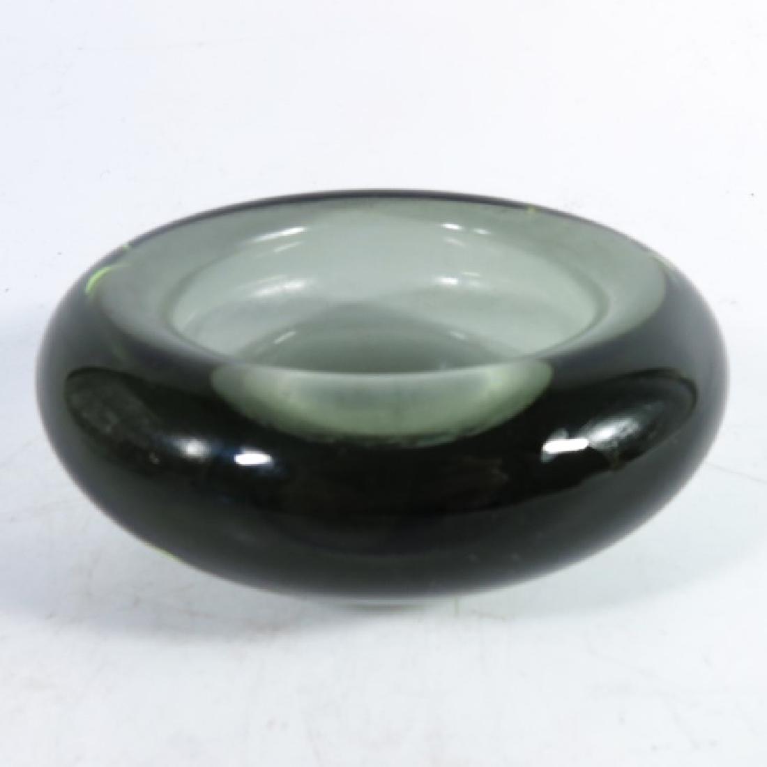 Per Lutken for Holmegaard, a smoky green glass Rondo: Per Lutken for Holmegaard, a smoky green glass Rondo vase, 1956, together with a bowl, number 160521 and another blue bowl, two signed, 8cm high (3)