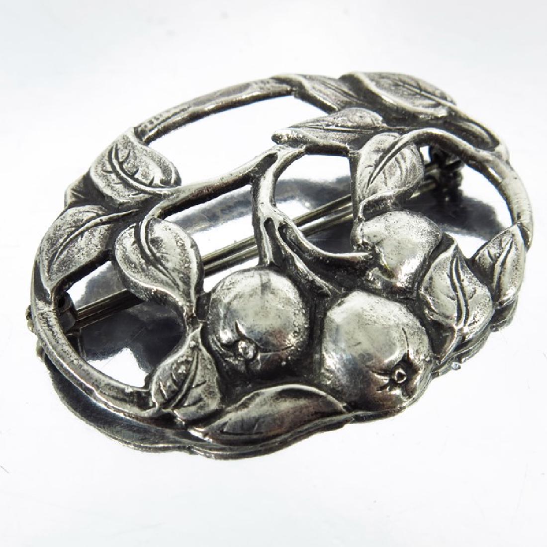 Bernard Instone, an Arts and Crafts silver brooch,: Bernard Instone, an Arts and Crafts silver brooch, circa 1920, pierced and modelled in relief with fruiting plant, marked sterling, 5cm
