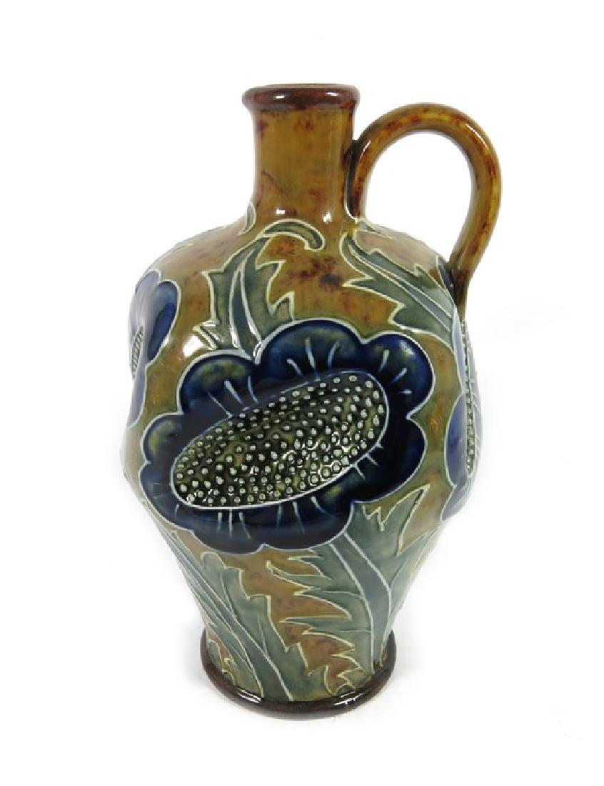 Arthur Pearce for Doulton Lambeth, a stoneware ewer,: Arthur Pearce for Doulton Lambeth, a stoneware ewer, circa 1891, shouldered form, heavily dimpled and tubelined with flower heads and foliage, impressed and incised marks, 20cm high