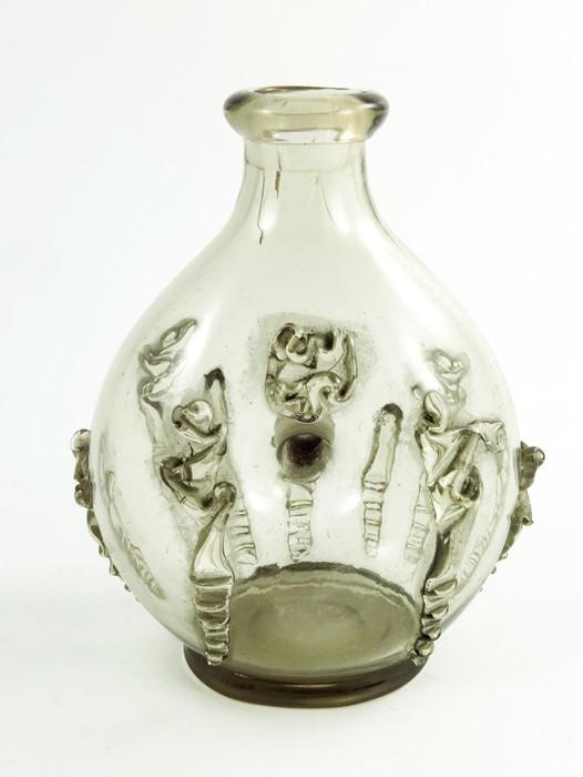 An Arts and Crafts glass decanter, probably Holmegaard,: An Arts and Crafts glass decanter, probably Holmegaard, in the 17th century style, ovoid form with central hole to the body, applied with rigaree banding, 17.5cm high Category: Glass