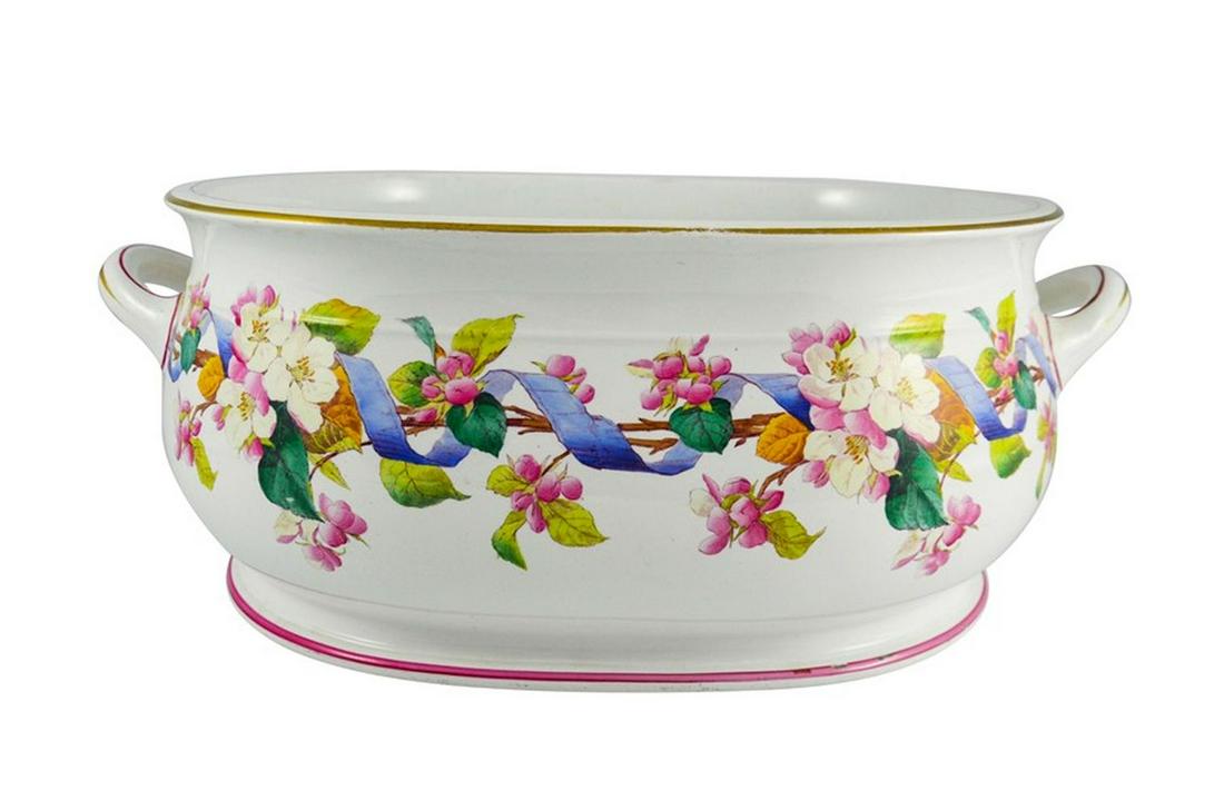 A Minton footbath, 1888, oval baluster form with two: A Minton footbath, 1888, oval baluster form with two handles, printed and painted with a wreath of ribbon entwined dog roses, gilded to the rim, impressed marks, 51cm wide, 34cm deep, 20cm high Catego