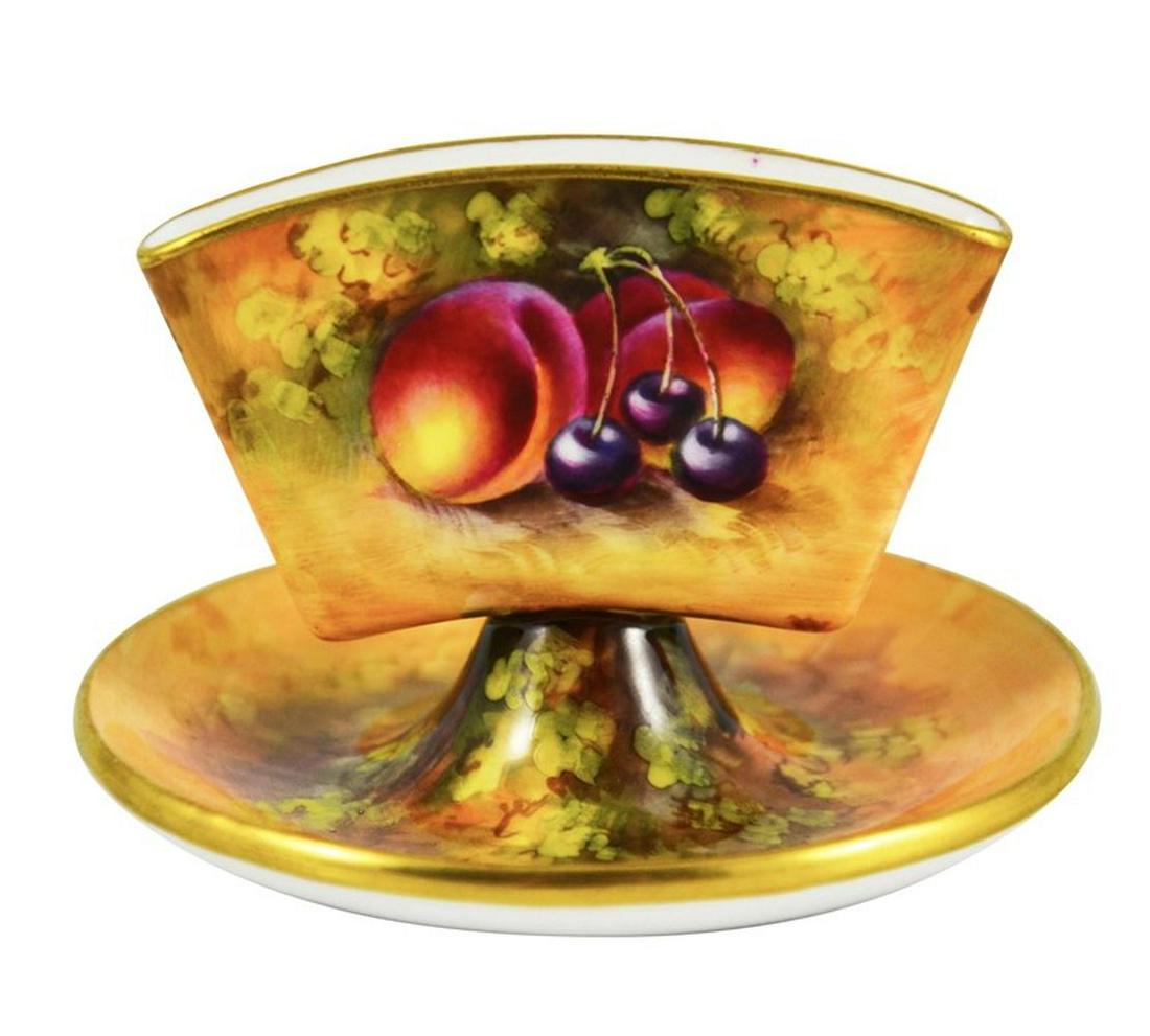 A Royal Worcester Cigarette Holder, 1931, hand painted: A Royal Worcester Cigarette Holder, 1931, hand painted and gilded, decorated with fruit on a naturalistic ground, unsigned, puce backstamp, 7cm high Category: Royal Worcester