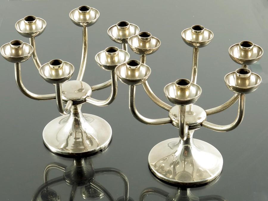 Robert Welch, a pair of Modernist silver six branch: Robert Welch, a pair of Modernist silver six branch candelabra, London 1975, the bases of capstan form, with tubular arms eminating from the central bosse, each teminating in a hemispherical cup sconc