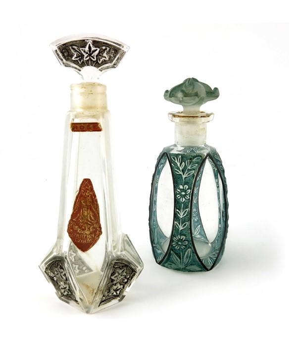Julien Viard (attributed), two glass perfume bottles,: Julien Viard (attributed), two glass perfume bottles, circa 1925, one with black stained moulded ivy motifs with paper label Parfum Exquis Rose, the other blue stained with black enamel, the edges wit