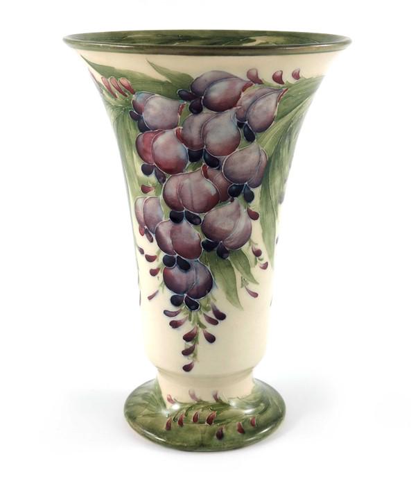 William Moorcroft for James MacIntyre, a Wisteria on: William Moorcroft for James MacIntyre, a Wisteria on white vase, 1913, footed trumpet form, printed mark and underglaze green signature and date, 24.5cm high