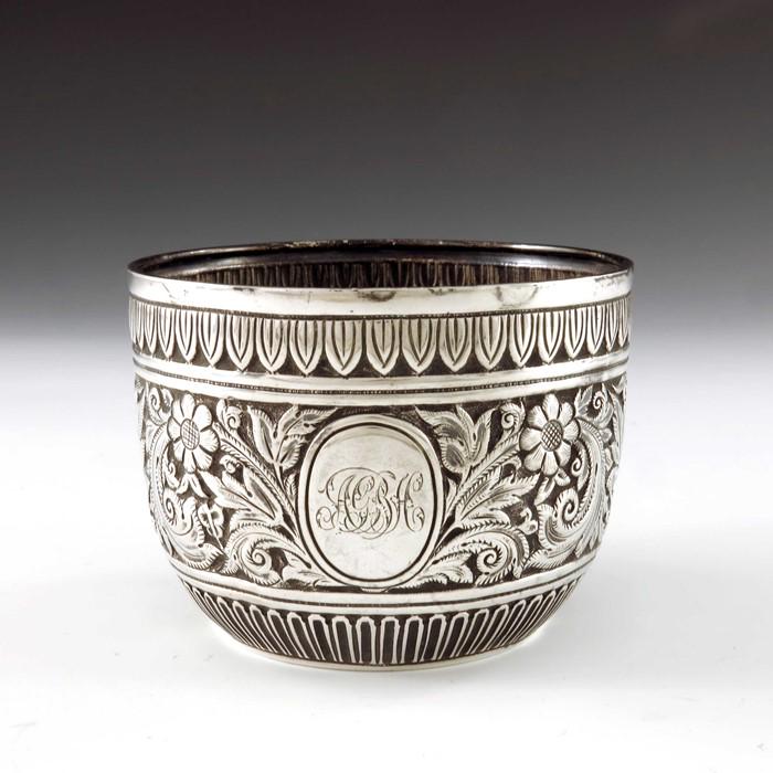 A Victorian silver bowl, Charles Stuart Harris, London: A Victorian silver bowl, Charles Stuart Harris, London 1886, embossed in the Persian style with a band of foliate scrolls between fluted and lappet borders, 10.5cm diameter, 5.14ozt