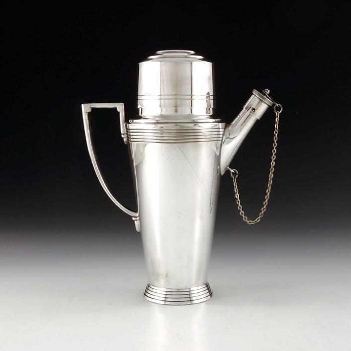 Keith Murray for Mappin and Webb, an Art Deco silver: Keith Murray for Mappin and Webb, an Art Deco silver plated cocktail shaker, circa 1933, shouldered conical form with bands of concentric rings, angled and stepped handle, the pouring spout with bayon