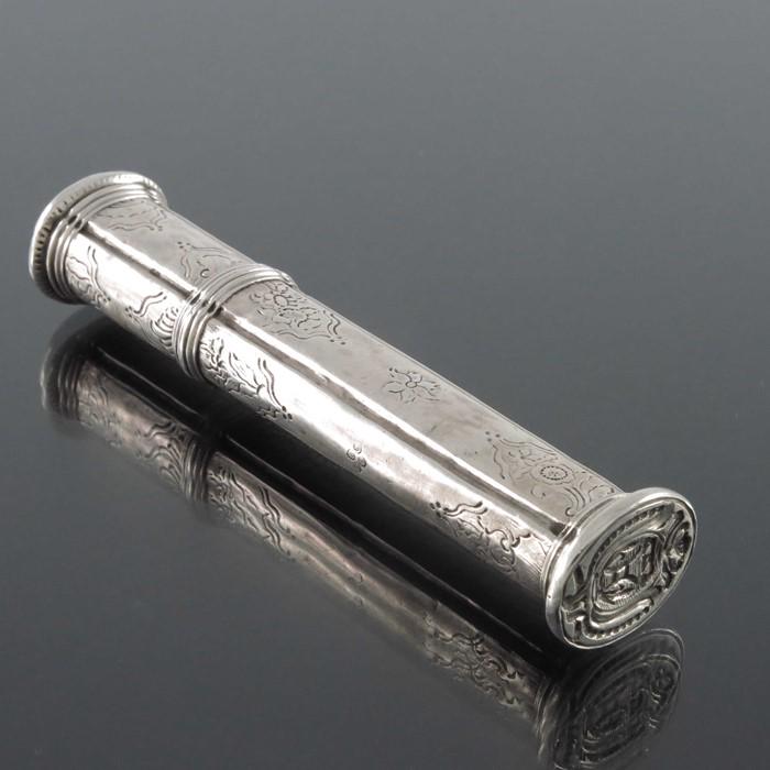 A Louis XV French silver sealing wax case, GV, Paris: A Louis XV French silver sealing wax case, GV, Paris 1738, channelled oval form, etched with Rococo floral sprigs and shells, the lid with a windmill vignette, incuse seal to base, 11cm long, 1.30ozt