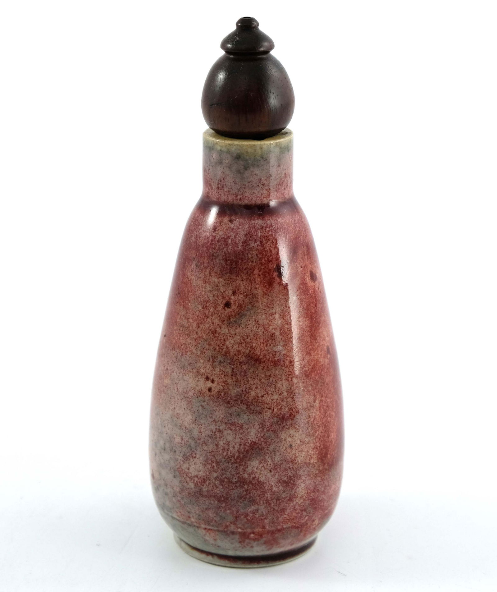 Ruskin Pottery, a High Fired scent bottle, circa 1920,: Ruskin Pottery, a High Fired scent bottle, circa 1920, rounded conical form, with screw thread and wooden stopper, ox blood and mottled grey flambe glaze, impressed marks, 13cm high