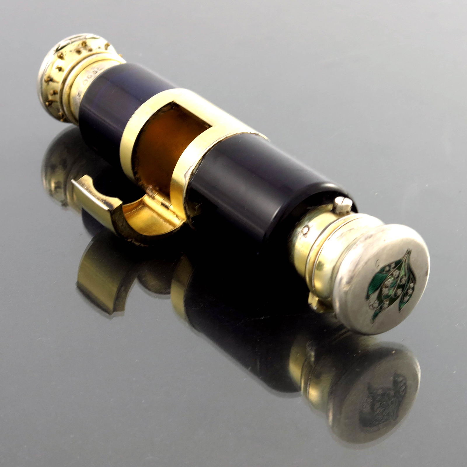 A Victorian silver gilt, enamel and glas: A Victorian silver gilt, enamel and glass combination scent bottle, Thomas Johnson, London 1862, cylindrical form, the central section with hinged pill box compartment, uniting two blue glass bottles,