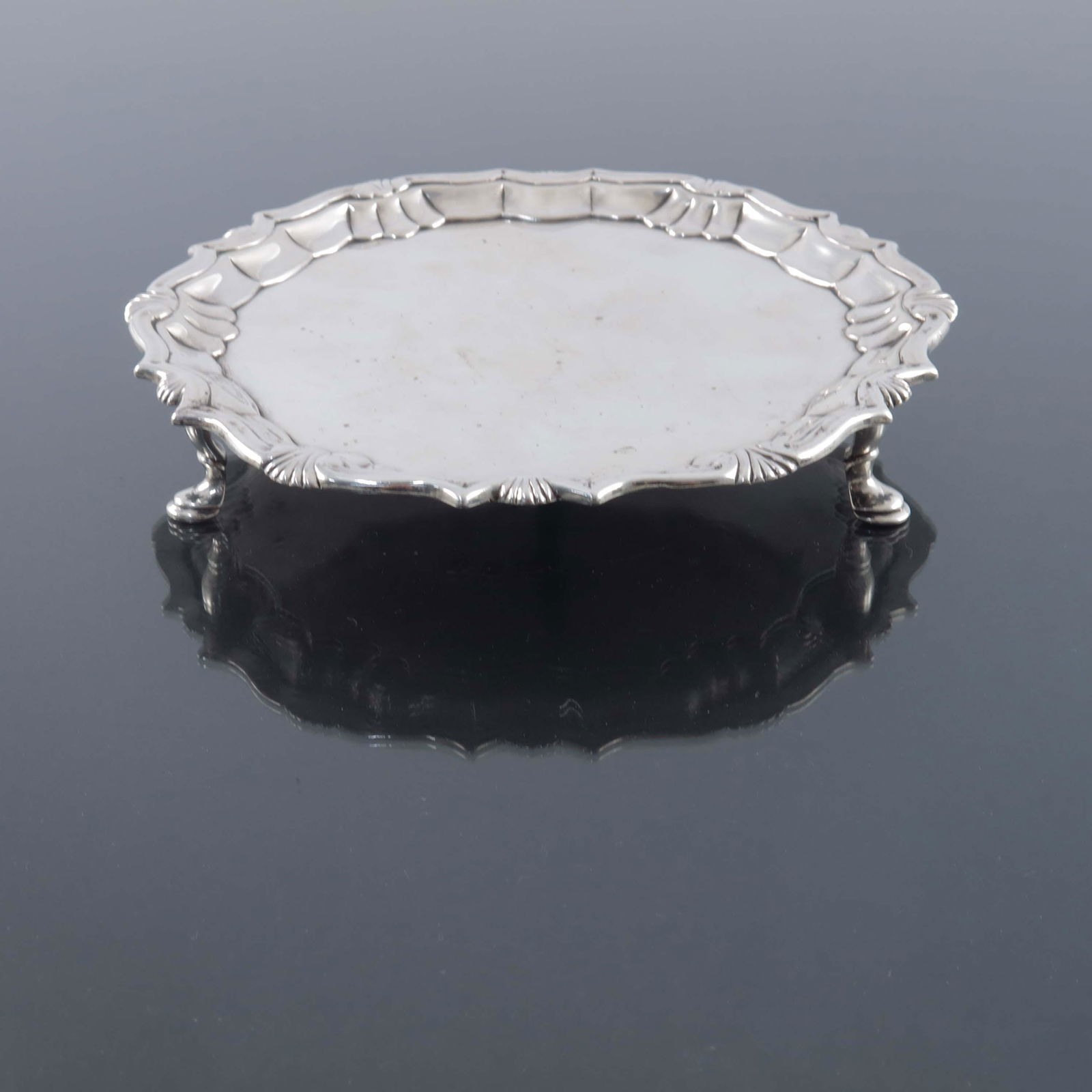 A George II silver salver, Robert Abercr: A George II silver salver, Robert Abercromby, London 1741, fluted ogee and shell border, on three stepped pad feet, 15.5cm diameter, 6.27ozt