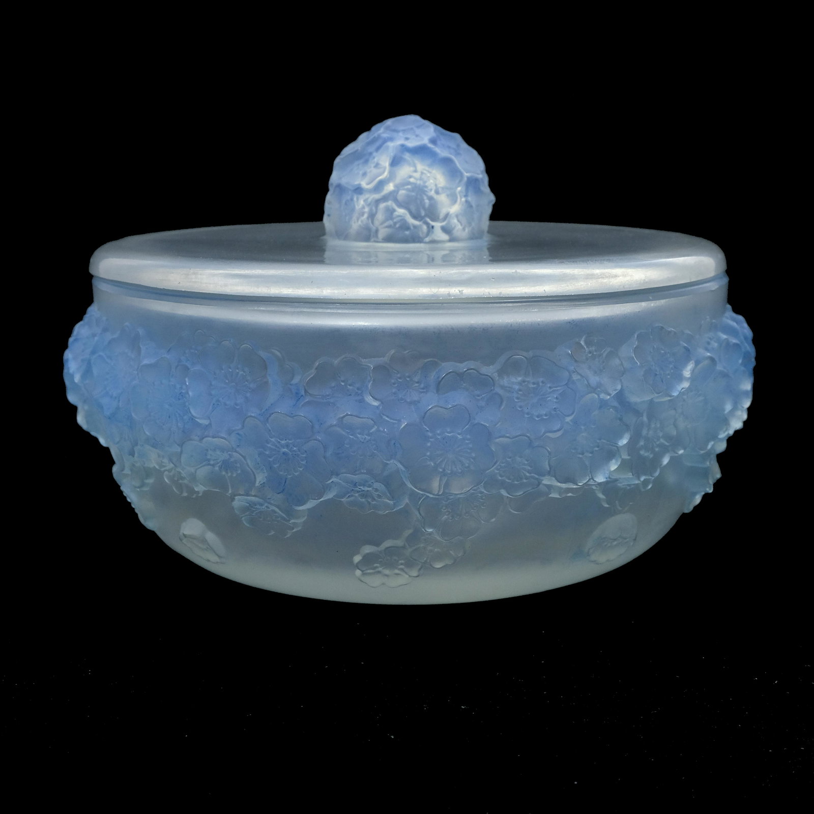 Rene Lalique, a Primeveres opalescent gl: Rene Lalique, a Primeveres opalescent glass box, model 77, designed circa 1927, frosted and blue stained, moulded intaglio mark R Lalique, wheel engraved France, 16.5cm diameter
