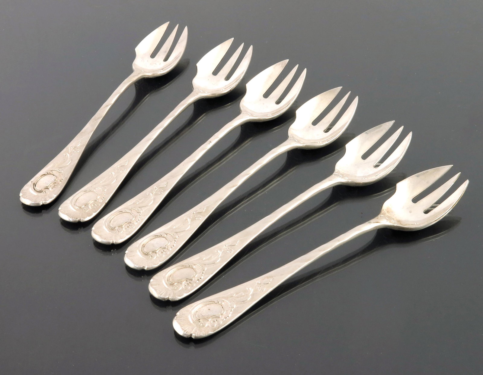 A set of six German silver oyster forks,: A set of six German silver oyster forks, Lazarus Posen, Frankfurt circa 1890, wrythen ribbon striped satin finish handles, cast with shell and Rococo foliate scroll cartouches, bright polished spork b