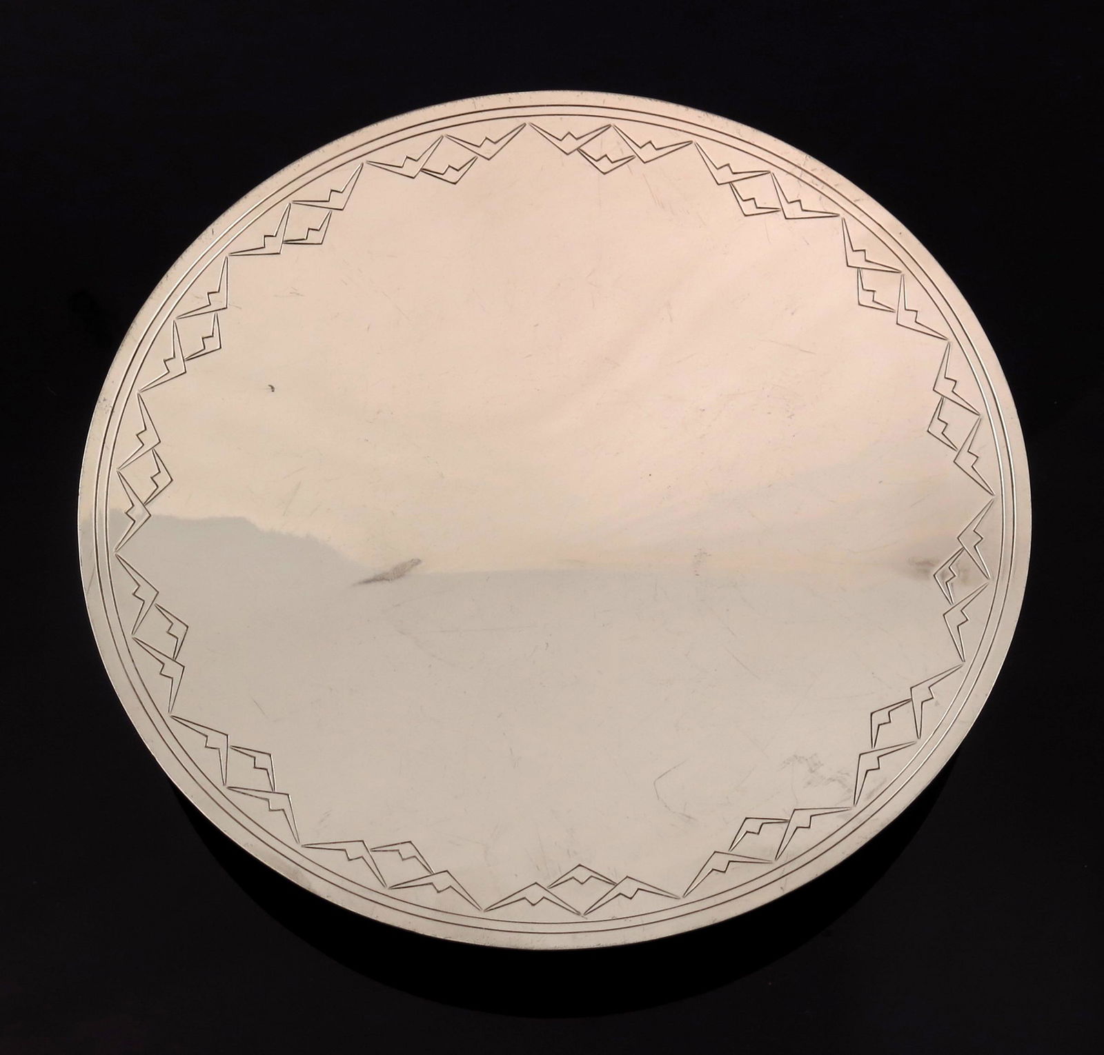 Keith Murray for Mappin and Webb, an Art: Keith Murray for Mappin and Webb, an Art Deco silver plated comport, circa 1934, circular shallow dished form, engraved with a band of concentric rings and geometric batwing design, concentric ringed