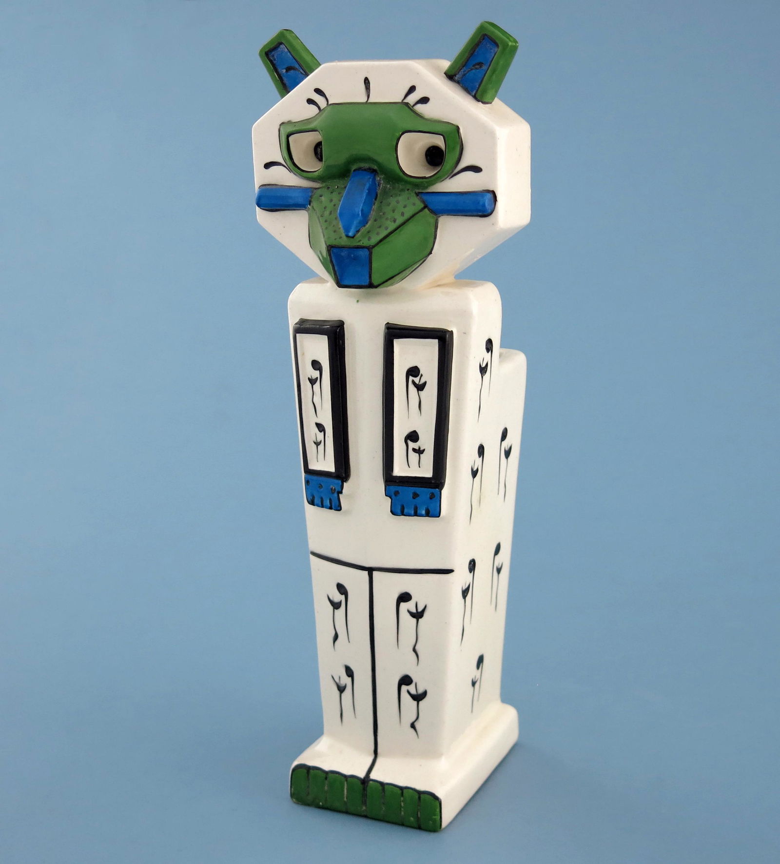Louis Wain for Amphora, a Futurist potte: Louis Wain for Amphora, a Futurist pottery Lucky Mascot Cat vase, circa 1919, modelled sitting upright, moulded meow meow notes to the body, highlighted in blue and green on white ground, incised sign