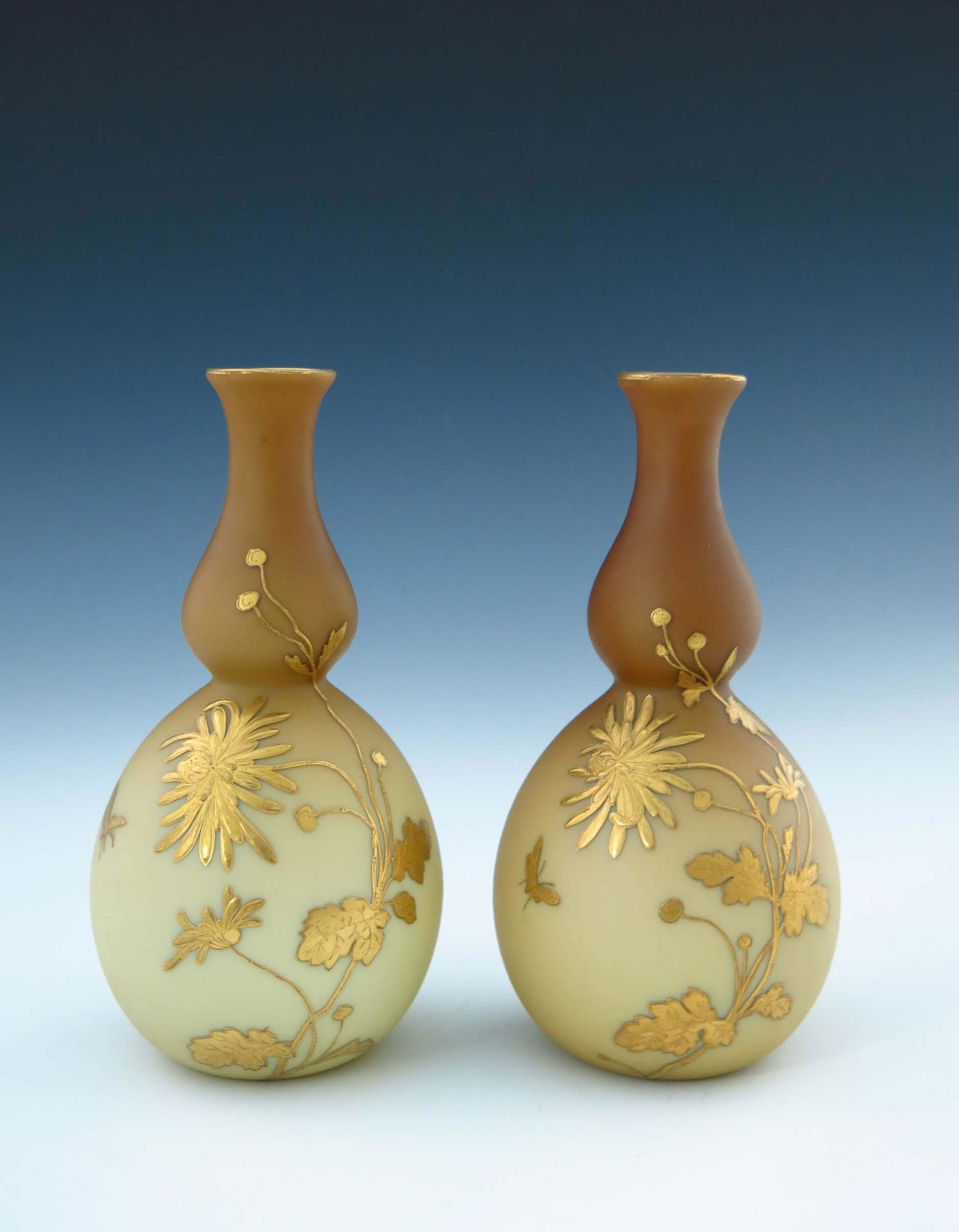 Jules Barbe for Thomas Webb, a pair of g: Jules Barbe for Thomas Webb, a pair of gilded satin glass vases, circa 1880, double gourd form, cased and variegated beige over opaque, decorated with raised gilt chrysanthemum and insect design, 22cm