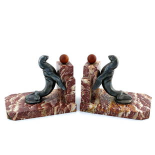 Maurice Frecourt, a pair of Art Deco pat: Maurice Frecourt, a pair of Art Deco patinated art metal and marble bookends, modelled as sealions and balls, 12.5cm high (2)