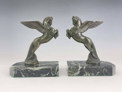 Maurice Frecourt, a pair of Art Deco bro: Maurice Frecourt, a pair of Art Deco bronze Pegasus bookends, circa 1925, each modelled as the winged horse leaping, on green marble bases, signed in the cast Frecourt, 18cm high (2)