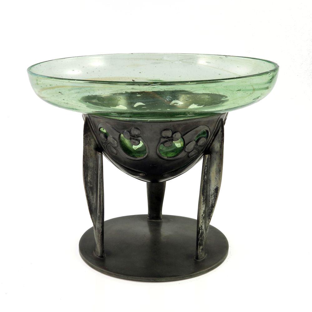Archibald Knox for Liberty and Co., an A: Archibald Knox for Liberty and Co., an Arts and Crafts Tudric pewter and Clutha glass comport, model 0276, the double ogee marbled aventurine glass bowl, supported in a pierced foliate tendril dish on