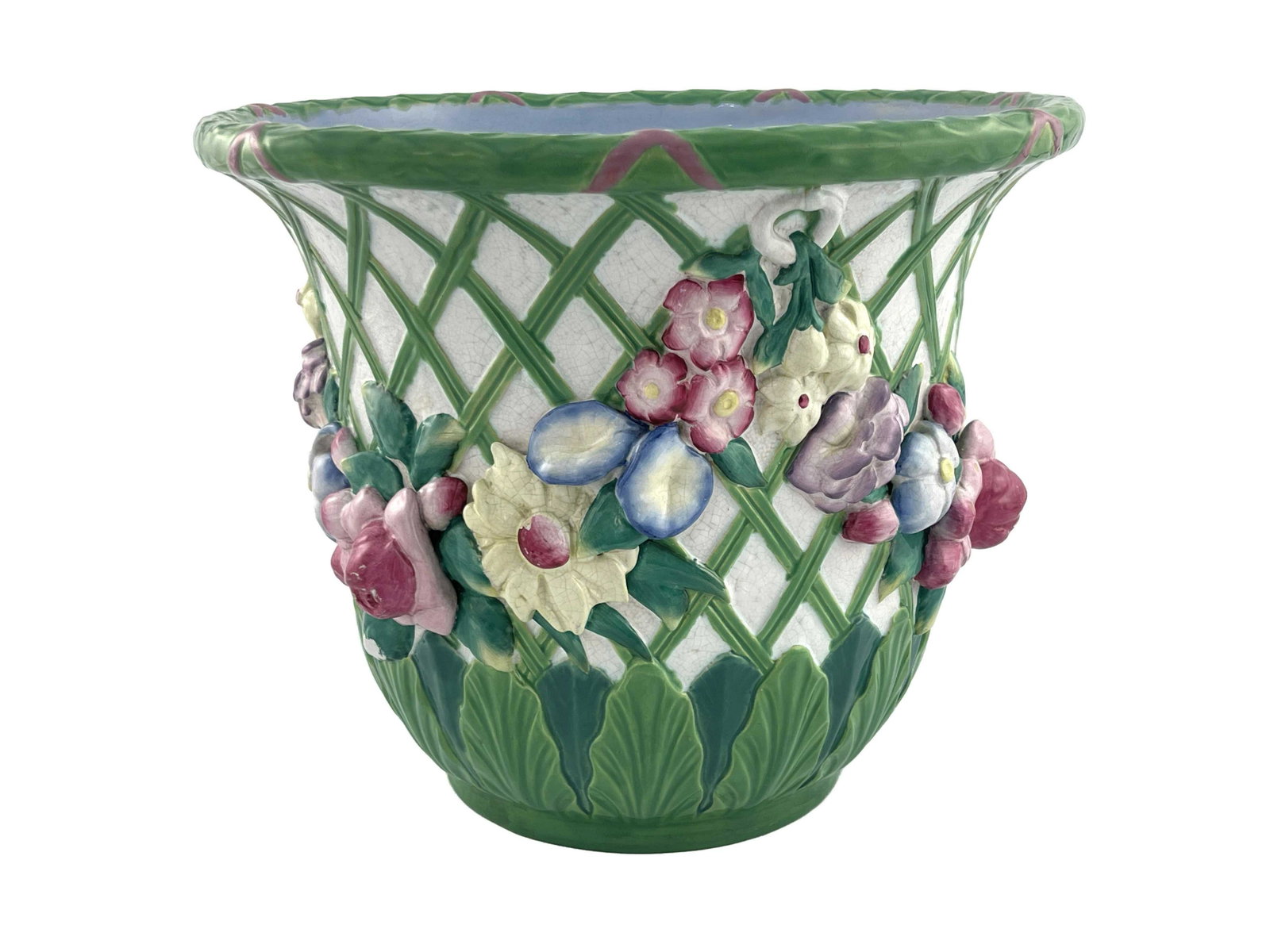 A Minton majolica jardiniere, 1870, bell: A Minton majolica jardiniere, 1870, bell form, modelled in high relief with floral garlands on a trellis ground, above acanthus lappets, glazed in pastel colour, impressed marks, 28cm high